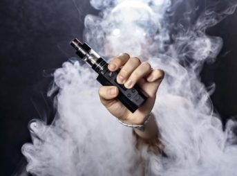 a man holding an e cigarette thumb 343x254 - 【まとめ】VAPE始めた頃の自分に言ってあげたい言葉【オーセン/クローン/海外購入の嘆き】